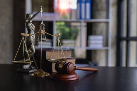 Hammer. Scales for Justice and Scales of Justice Justitia Lady Judge on black wooden background. Law books on the desk in the office