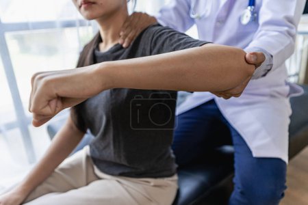 Photo for Male therapist treating injured shoulder on female athlete's shoulder Post traumatic muscle rehabilitation, sports physiotherapy, recovery concept. - Royalty Free Image