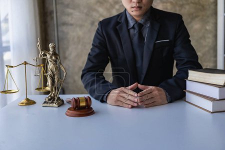 Photo for Lawyer, modern office, in formal attire. Golden scales law book, working on real estate and contract documents. Arguments for a defensive strategy fight for freedom - Royalty Free Image