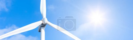 Detail of Wind Power with bright sun and blue sky in background. Energy supply, eolic turbine - Powerplant and high voltage supply concept.