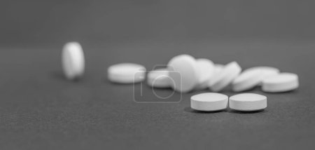 Photo for White pills on black background with copy space - Royalty Free Image