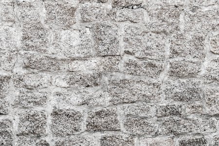 Foto de Old light gray stone wall background. Closeup front view of stone wall texture - Imagen libre de derechos