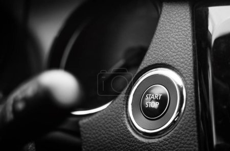 Engine start and stop button on dashboard. Keyless smart key on a modern vehicle