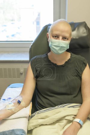 A Young woman in hospital bed suffering from breast cancer receiving treatment