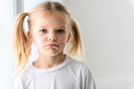 A Negative human emotions, reactions and feelings. shot of moody displeased angry little girl