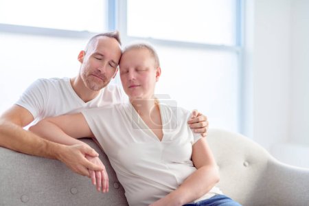 A woman with Breast cancer in a bright room with her boyfriend
