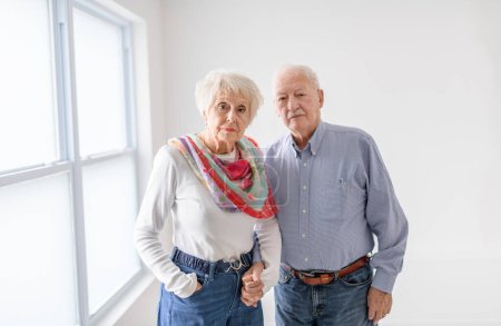 A senior retired couple having great moment together close to a window