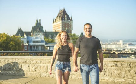 A Quebec summer travel tourists couple in front of Frontenac Chateau, Old Quebec.