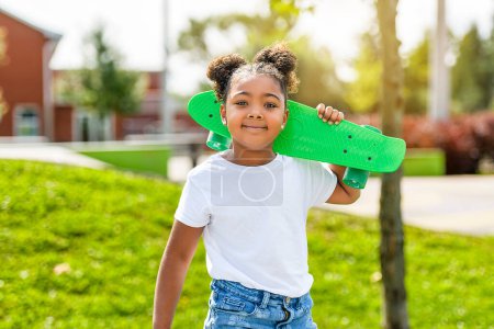 A child skater or kid girl playing skateboard outside
