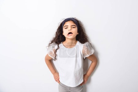 A curly dark hair child girl over white background
