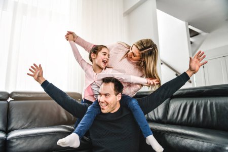 A Dad and mother with his cute little girl on a modern house