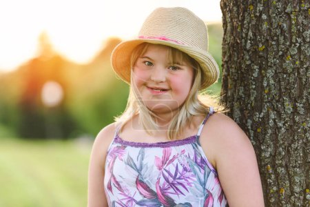 A portrait of child girl outside in summer season with hat