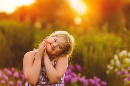 A portrait of child girl outside in summer season at the sunset