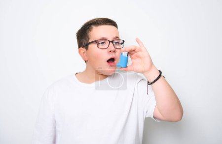 A child using inhaler for asthma over White background studio