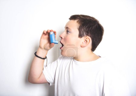 A child using inhaler for asthma over White background studio
