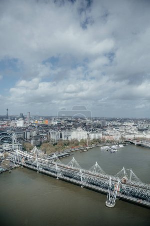 Captured from the London Eye, this aerial photograph showcases the Hungerford Bridge and Golden Jubilee Bridges spanning across the River Thames