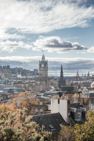 A panoramic view of Edinburgh showcasing historic buildings and landmarks under a partly cloudy sky