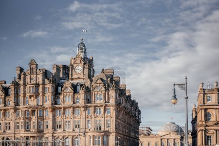 The historic Balmoral Hotel in Edinburgh with its iconic clock tower and intricate architectural details under a clear sky
