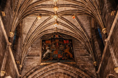The intricate vaulted ceiling and royal coat of arms inside St Giles Cathedral in Edinburgh, showcasing detailed gothic architecture