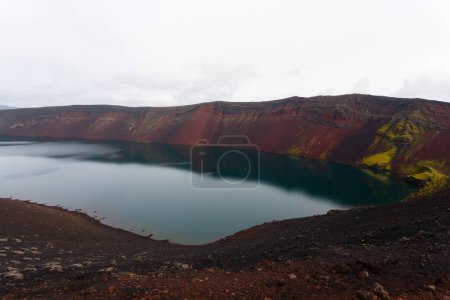 Volcanic crater with water near Landmannalaugar area, Iceland. Colored mountains