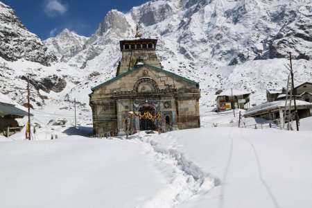 Photo for Kedarnath temple, shrine covered with snow. Kedarnath temple is a Hindu temple dedicated to Shiva. Located on the Garhwal Himalayan range near the Mandakini river. - Royalty Free Image