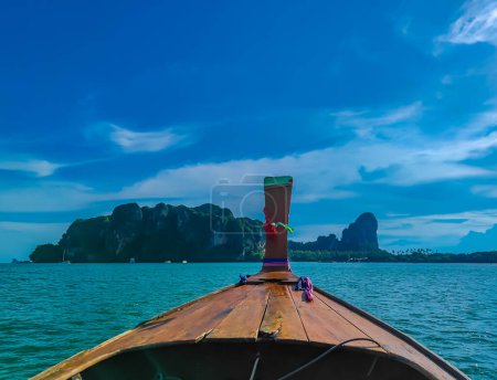 Photo for First person view of a swimming towards an island with a traditional long tail boat in Andaman sea in Thailand, Krabi province - Royalty Free Image