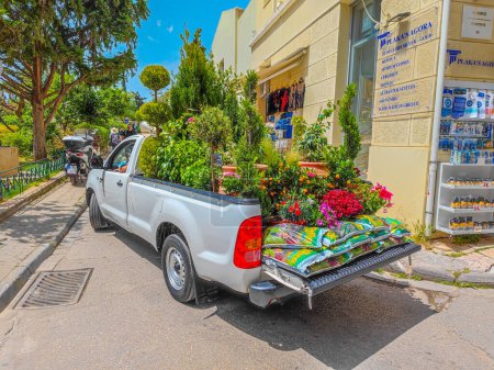 Photo for 03 15 2023 - Athens, Greece. Image of open car trunk full of various beautiful potted plants and fertilizers. Concept of respect for the environment - Royalty Free Image