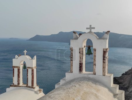 Photo for Archs with bells of Church of Agios Nikolaos in Oia town in Santorini island, Greece - Royalty Free Image