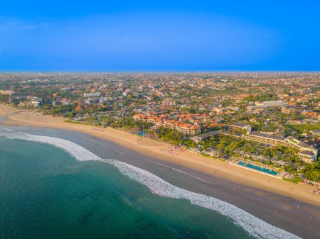 Photo for Aerial view of Seminyak beach coastline. The famous and luxury Kuta beach resort in southern Bali, Indonesia. Sunny day drone photo - Royalty Free Image
