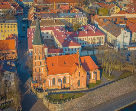 Kaunas old town, Lithuania. Drone aerial view of Kaunas city center with many old red roof houses and Vytautas Magnus church in front