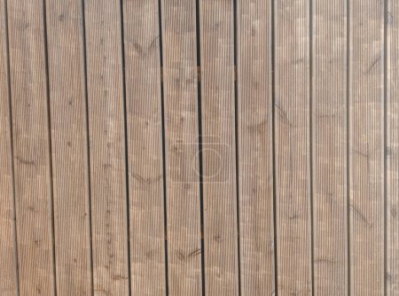 Terrasse en bois cannelé de mélèze sibérien imprégnée d'huile avant peinture. Vue du dessus du pont des planches de bois