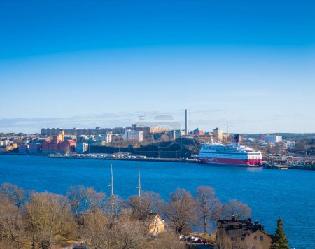 A large cruise ship docked at the shore of Stockholm, Sweden. Drone top panorama photo