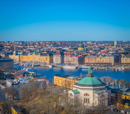 Eric Ericsonhallen in front of Ostermalm coastline. Stockholm old town next to Gamla stan. Aerial view of Sweden capital. Drone top panorama photo