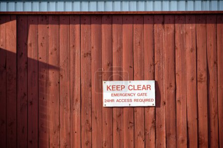 Photo for Keep clear emergency access required sign on wall UK - Royalty Free Image