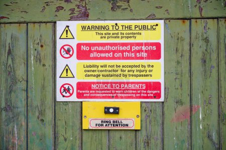 Photo for Construction site health and safety message rules sign board signage on fence boundary UK - Royalty Free Image
