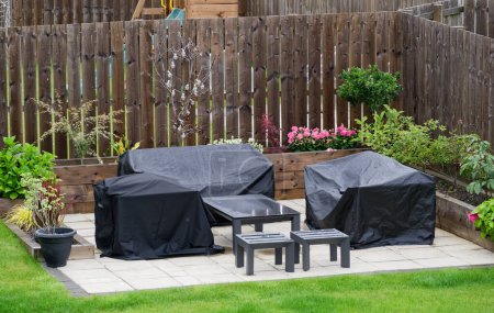Garden plant display and outdoor furniture during summer UK