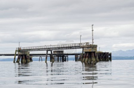 Photo for Old derelict wooden jetty pier in sea at Inverkip power station UK - Royalty Free Image