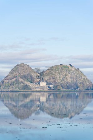 Photo for Dumbarton castle on volcanic rock overlooking the River Clyde UK - Royalty Free Image
