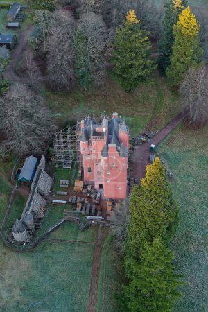Photo for Craigievar Castle during conservation work to paint the walls pink UK - Royalty Free Image