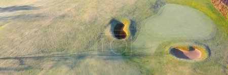 Golf course green aerial view and two players UK