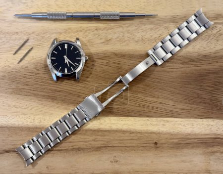 Watch case and bracelet after being polished on wooden board