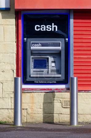 Cash machine in wall outside bank in city centre UK