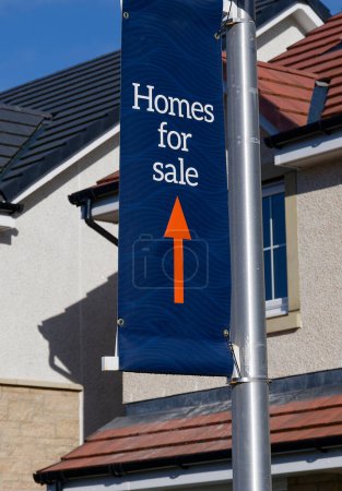 Home for sale sign at new housing development UK