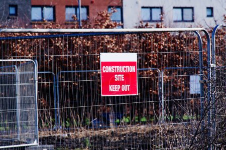 Construction site keep out sign on fence UK