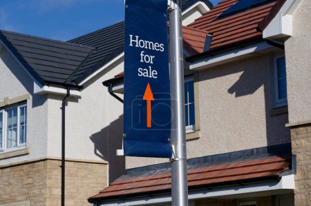 Home for sale sign at new housing development UK