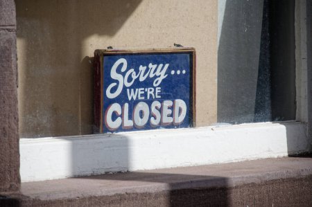 Sorry we are closed sign in shop window UK