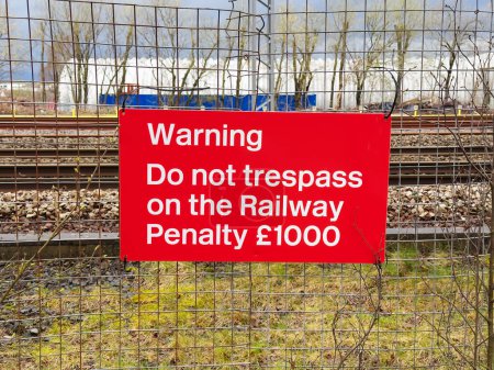 Trespass warning sign and penalty notice at railway UK