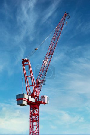 Tower crane high in sky at construction site UK