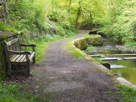 Empty bench seat at riverside footpath UK