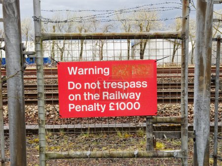 Trespass warning sign and penalty notice at railway UK